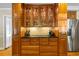 Kitchen cabinetry with glass doors, stone counter, stainless steel fridge and hardwood floors at 998 Ferncliff Ne Rd, Atlanta, GA 30324