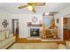 Charming living room with a fireplace, wood floors, staircase, and view of other rooms at 998 Ferncliff Ne Rd, Atlanta, GA 30324