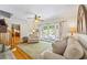 Cozy living room features wood floors, comfortable seating, and French doors leading to outdoor patio area at 998 Ferncliff Ne Rd, Atlanta, GA 30324