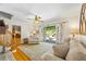 Bright living room with wood floors, a ceiling fan, and French doors leading to an outdoor patio area at 998 Ferncliff Ne Rd, Atlanta, GA 30324