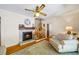 Inviting living room featuring a fireplace, hardwood floors, staircase, and natural light for a warm ambiance at 998 Ferncliff Ne Rd, Atlanta, GA 30324