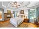 Relax in this beautiful main bedroom offering a stone fireplace, tray ceilings and bright windows at 998 Ferncliff Ne Rd, Atlanta, GA 30324