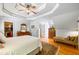 This primary bedroom boasts wood floors, a ceiling fan, a dressing area, and ample space at 998 Ferncliff Ne Rd, Atlanta, GA 30324