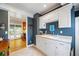 Mudroom features white cabinets, a sink, and a view into the kitchen and backyard at 998 Ferncliff Ne Rd, Atlanta, GA 30324
