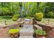 Outdoor kitchen with a stone-paved area, BBQ grill, and lush green surroundings perfect for entertaining guests at 998 Ferncliff Ne Rd, Atlanta, GA 30324