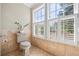 Cozy powder room with neutral tones, plantation shutters, and natural light at 998 Ferncliff Ne Rd, Atlanta, GA 30324
