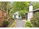 Landscaped backyard with gravel pathway, patio, and shed, complemented by mature trees and lush plantings at 224 Kings Hwy, Decatur, GA 30030