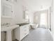 Bright bathroom features double sinks with black countertops, a clawfoot tub, and stylish black and white floors at 224 Kings Hwy, Decatur, GA 30030