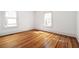 Sunlit bedroom featuring hardwood floors, two windows, and neutral walls, creating a warm and inviting space at 224 Kings Hwy, Decatur, GA 30030