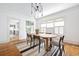 Bright dining room with wood floors, large windows, and an elegant light fixture at 224 Kings Hwy, Decatur, GA 30030