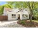 Attractive white brick home with a cozy front porch, fresh landscaping, and a concrete driveway at 224 Kings Hwy, Decatur, GA 30030