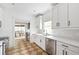 Bright kitchen featuring white cabinets, quartz countertops, stainless steel appliances, and patio access at 224 Kings Hwy, Decatur, GA 30030