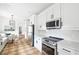 Bright kitchen featuring white cabinets, quartz countertops, stainless steel appliances, and breakfast nook at 224 Kings Hwy, Decatur, GA 30030