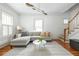 Bright living room features a sectional sofa, hardwood floors, and a decorative oar-themed light fixture at 224 Kings Hwy, Decatur, GA 30030