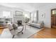 Bright living room with a cozy fireplace, modern furnishings, and hardwood floors at 224 Kings Hwy, Decatur, GA 30030