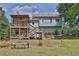 Expansive backyard featuring a spacious two-story deck, hammock, and mature trees perfect for outdoor enjoyment at 2675 Dacula Ridge Dr, Dacula, GA 30019