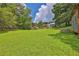 Large, well-maintained backyard with mature trees, offering ample space for recreation and relaxation in a private setting at 2675 Dacula Ridge Dr, Dacula, GA 30019