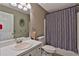 Clean bathroom with a single sink vanity, toilet, and a shower with a patterned curtain at 2675 Dacula Ridge Dr, Dacula, GA 30019