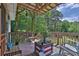 Cozy outdoor deck featuring casual seating, decor, and tree lined views for relaxation and entertainment at 2675 Dacula Ridge Dr, Dacula, GA 30019