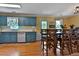 Bright dining area with blue kitchen cabinets, tile backsplash, and access to a kitchen table at 2675 Dacula Ridge Dr, Dacula, GA 30019