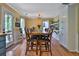 Open dining area featuring a large wooden table, hardwood floors, and natural light from multiple windows at 2675 Dacula Ridge Dr, Dacula, GA 30019