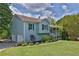 Charming home exterior with blue siding, well-manicured landscaping, and an attached two-car garage at 2675 Dacula Ridge Dr, Dacula, GA 30019