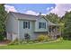 Charming home with light blue siding, front porch, lush lawn, and beautiful landscaping at 2675 Dacula Ridge Dr, Dacula, GA 30019