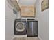 Modern laundry room with side-by-side washer and dryer at 2675 Dacula Ridge Dr, Dacula, GA 30019