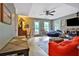 Living room featuring a ceiling fan, red sofa, television and exterior door at 2675 Dacula Ridge Dr, Dacula, GA 30019