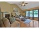 Bright living room featuring a vaulted ceiling, hardwood floors, comfortable seating, and natural light from multiple windows at 2675 Dacula Ridge Dr, Dacula, GA 30019