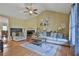 Spacious living room with vaulted ceilings, hardwood floors, comfortable seating, and a cozy fireplace at 2675 Dacula Ridge Dr, Dacula, GA 30019