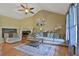 Cozy living room with vaulted ceilings, hardwood floors, comfortable seating and a decorative fireplace at 2675 Dacula Ridge Dr, Dacula, GA 30019