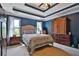 Comfortable main bedroom featuring a queen-sized bed, tray ceilings, and ample natural light at 2675 Dacula Ridge Dr, Dacula, GA 30019
