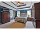 Large primary bedroom suite with a tray ceiling, neutral carpet, and ensuite bathroom in the background at 2675 Dacula Ridge Dr, Dacula, GA 30019