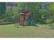 Backyard featuring a wooden playground with a slide and swings, perfect for Gathering fun and outdoor activities at 2675 Dacula Ridge Dr, Dacula, GA 30019