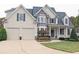 Charming two-story home with a two-car garage, stone accents, manicured lawn and inviting front porch at 278 Vine Creek Dr, Acworth, GA 30101