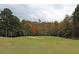 Scenic view of the golf course, showcasing the lush green fairway, sand trap and mature trees at 278 Vine Creek Dr, Acworth, GA 30101