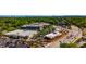 An aerial view of a commercial district with a busy street, parking lots, buildings, trees, and a distant city skyline at 754 Pinehill Se Dr, Smyrna, GA 30080