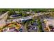 Aerial view of a shopping center with ample parking, surrounded by trees, streets, and other buildings at 754 Pinehill Se Dr, Smyrna, GA 30080