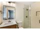 Bathroom features updated fixtures, a glass shower, and a window for natural light at 754 Pinehill Se Dr, Smyrna, GA 30080