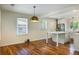 Spacious dining room with hardwood floors, a modern pendant light, and an open kitchen at 754 Pinehill Se Dr, Smyrna, GA 30080