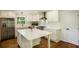 Well-lit kitchen featuring white cabinets, island, and stainless steel appliances at 754 Pinehill Se Dr, Smyrna, GA 30080