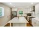 Modern kitchen with white cabinets, stainless steel appliances, and a marble countertop island at 754 Pinehill Se Dr, Smyrna, GA 30080