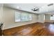 Inviting living room with hardwood floors, large windows, and a ceiling fan at 754 Pinehill Se Dr, Smyrna, GA 30080