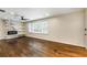 Bright living room featuring a fireplace, shelving, hardwood floors, and large windows at 754 Pinehill Se Dr, Smyrna, GA 30080