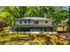 Expansive two-story home featuring a screened porch and a carport, surrounded by mature trees at 754 Pinehill Se Dr, Smyrna, GA 30080