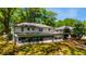 View of the back of the house, highlighting its screened porch, carport, and backyard at 754 Pinehill Se Dr, Smyrna, GA 30080