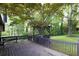 Private back deck with wooden railing and a gazebo surrounded by lush greenery at 1763 Hearthstone Cir, Lawrenceville, GA 30043