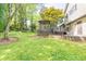 Expansive backyard featuring a wooden gazebo, deck, and lush greenery at 1763 Hearthstone Cir, Lawrenceville, GA 30043