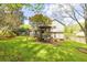Large backyard boasts a gazebo, lush lawn, and mature trees, creating a serene setting at 1763 Hearthstone Cir, Lawrenceville, GA 30043